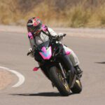 Hunter Storm, a novice rider with less than 650 miles on her motorcycle, navigating the INDE race track, learning the art of leaning into a turn. Experiencing the thrill with two riders in pursuit.