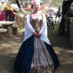 Hunter Storm as the Fairy Queen, Queen Titania, at the Fireland Faerie Festival, wearing a cobalt blue and gold gown with metallic fairy wings.